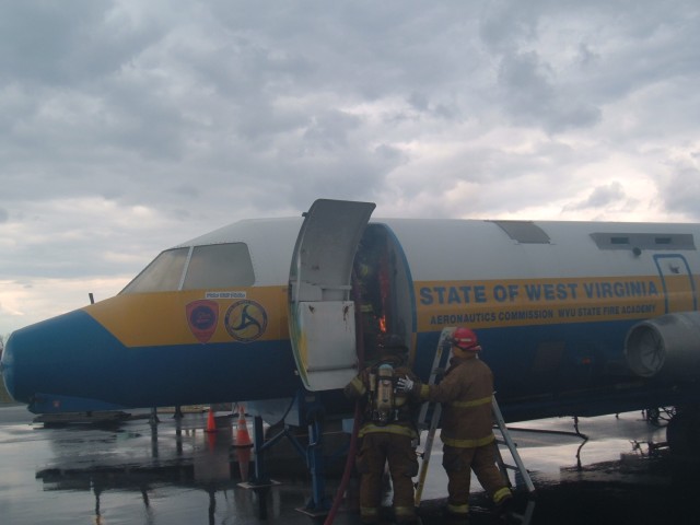 Fire crew working to put a fire out inside of the aircraft simulator  